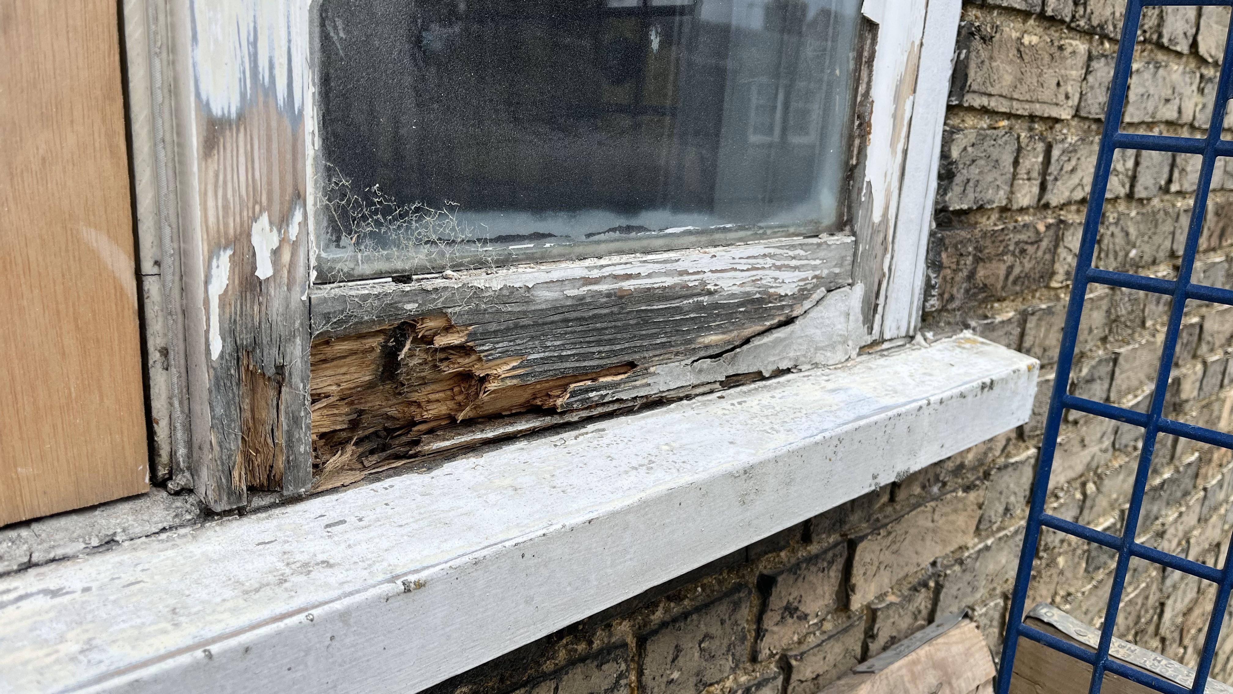 Fixing and old window in Buddhist centre Cambridge 