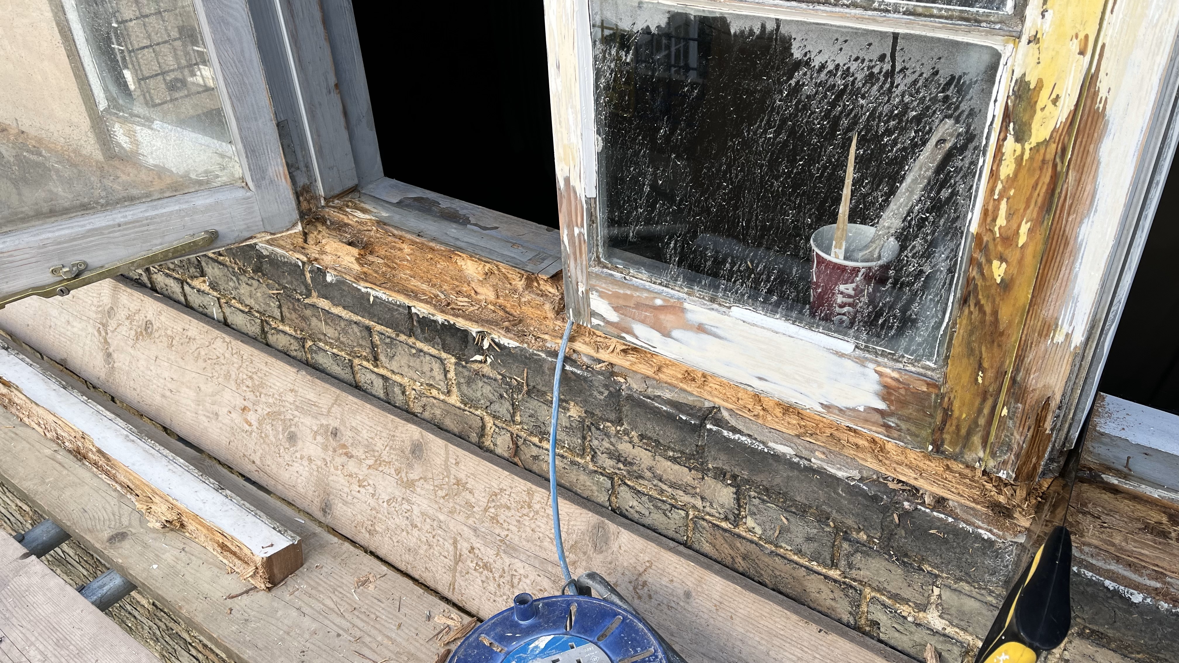 Fixing and old window in Buddhist centre Cambridge 