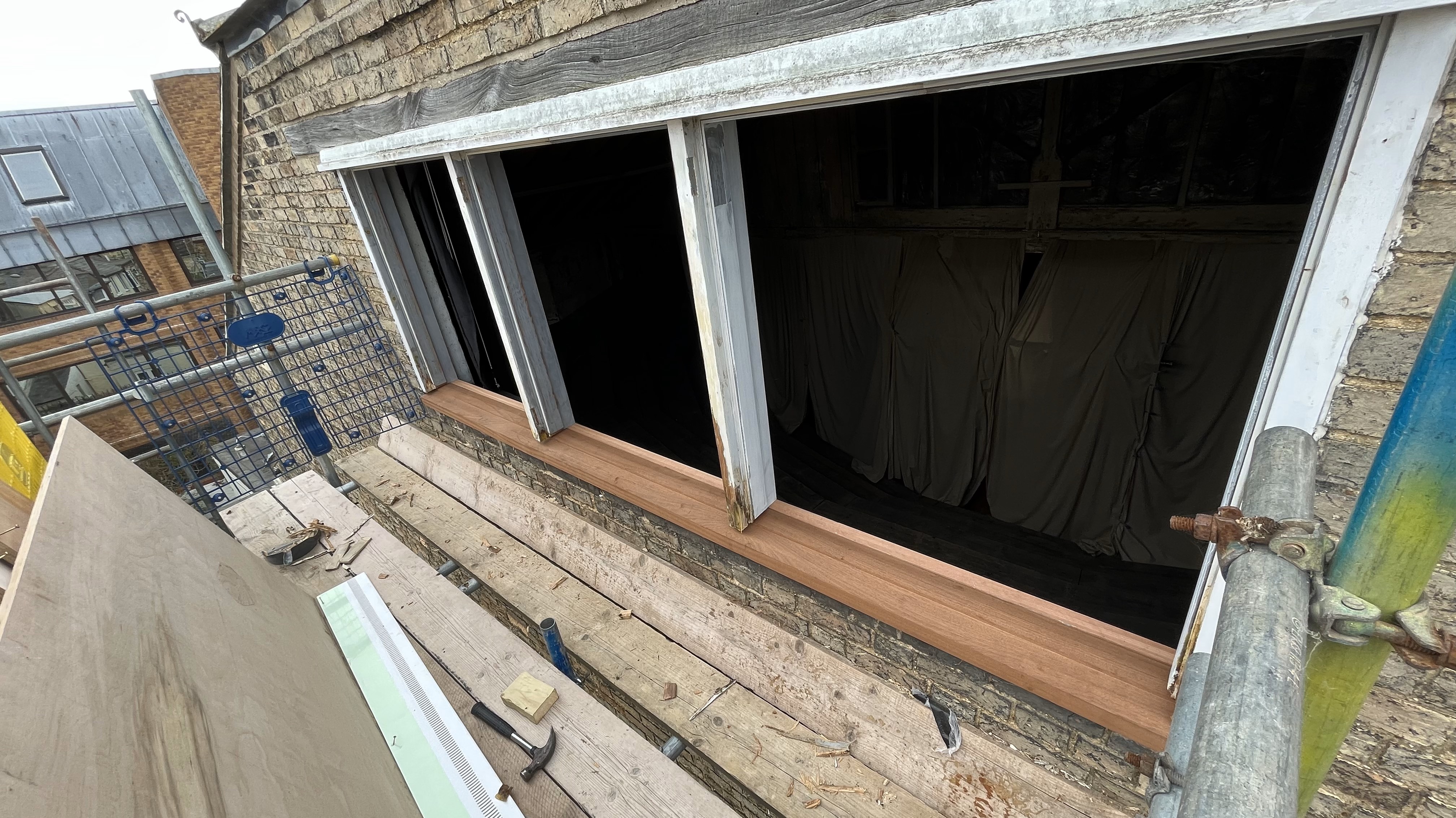 Fixing and old window in Buddhist centre Cambridge 